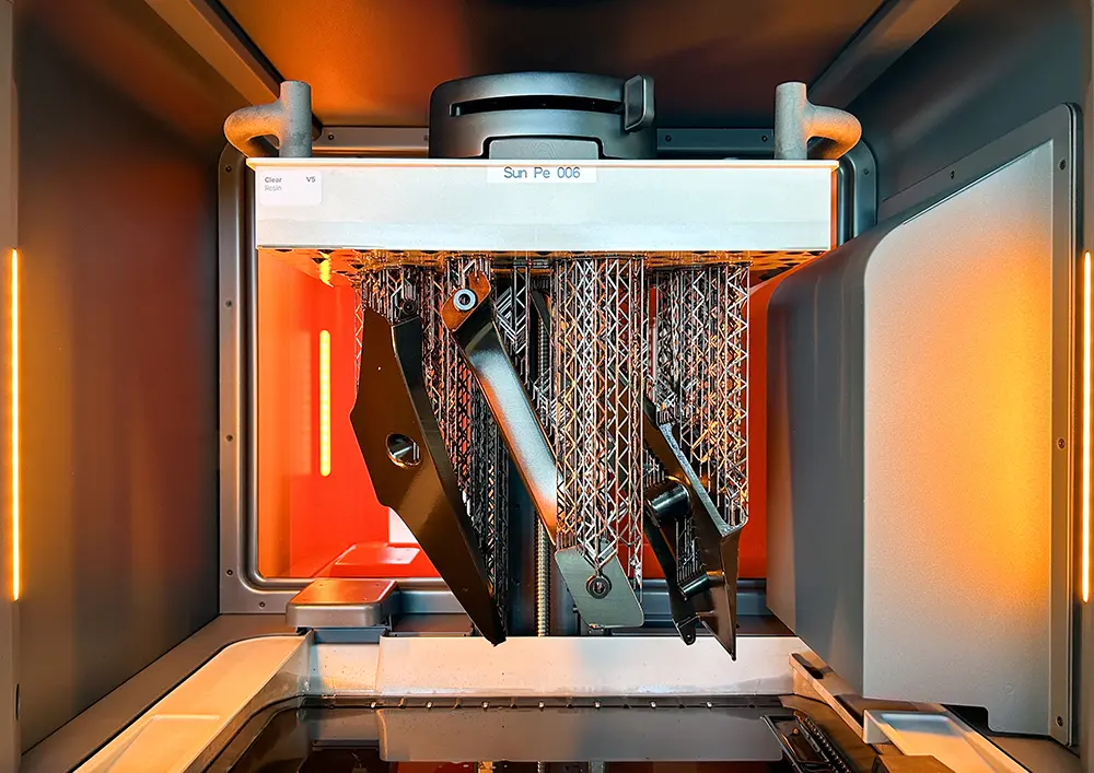 Black parts on build platform inside Form 4L 3D printer