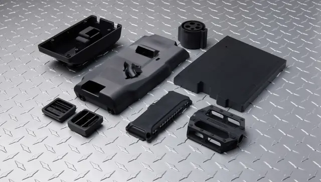 Very dark grey parts on a metal background