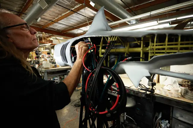 Person painting the inside of a mechanical shark
