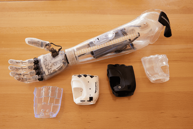 Clear bionic hand plus four hand prototypes in different materials